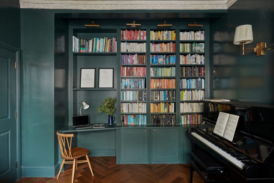 Deep green library with desk, shelving and piano